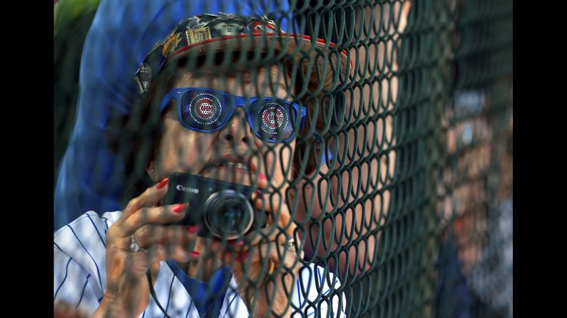 A Chicago Cubs fan watches the team practice in Mesa, Arizona, on Wednesday, February 24.