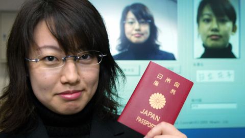 An employee of Hitachi demonstrates the new passport identify system developed by Hitachi and Glory Industry during a press preview at Hitachi's headquarters in Tokyo, 06 November 2003. The system can recognize one's identity even after the person has changed his/her hair-style, using glasses or even getting old.  Hitachi and Glory Industry will complete the new passport system until 2005 and are hoping to sell the identification system worldwide.