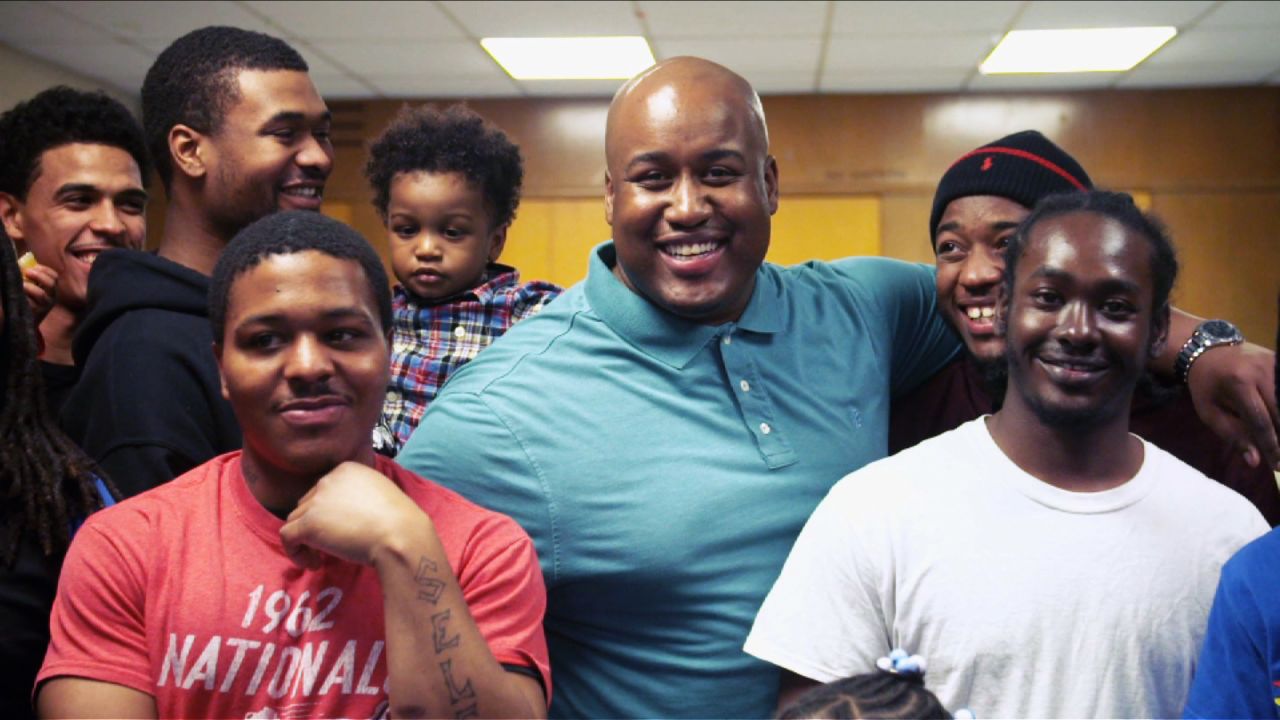 Smith, center, uses the Dovetail Project to help young fathers in Chicago become positive role models.