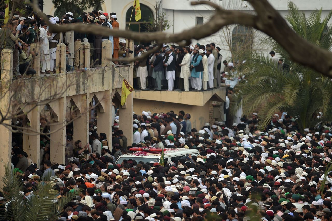 Supporters of the executed man offer funeral prayers for Qadri near the ambulance carrying his body a day after his execution.
