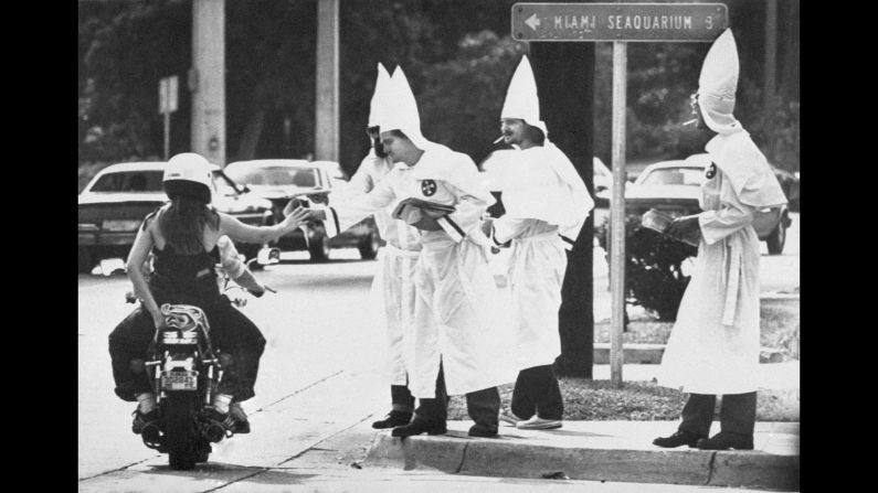 <strong>Racial tensions ignite:</strong> Ku Klux Klan members hand out propaganda at a busy Miami intersection on January 2, 1982, <a href="http://www.upi.com/Archives/1983/01/02/About-a-dozen-Ku-Klux-Klan-members-urging-support/9884410331600/" target="_blank" target="_blank">following violent riots</a> sparked by the killing of 20-year-old Nevell Johnson Jr. Johnson, a black man, was shot in the head by white officer Luis Alvarez at a video game arcade in Miami's Overtown neighborhood. Alvarez was later acquitted on manslaughter charges.