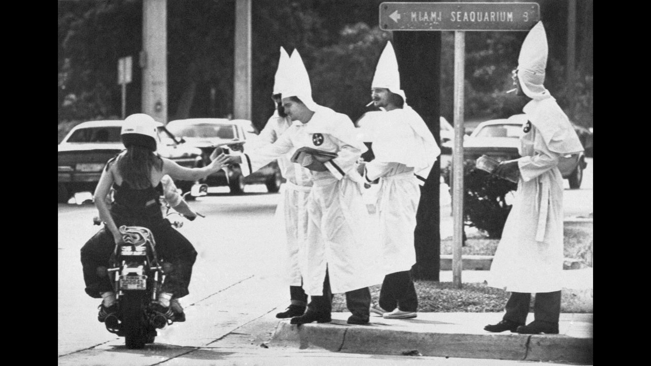 <strong>Racial tensions ignite:</strong> Ku Klux Klan members hand out propaganda at a busy Miami intersection on January 2, 1982, <a href="http://www.upi.com/Archives/1983/01/02/About-a-dozen-Ku-Klux-Klan-members-urging-support/9884410331600/" target="_blank" target="_blank">following violent riots</a> sparked by the killing of 20-year-old Nevell Johnson Jr. Johnson, a black man, was shot in the head by white officer Luis Alvarez at a video game arcade in Miami's Overtown neighborhood. Alvarez was later acquitted on manslaughter charges.