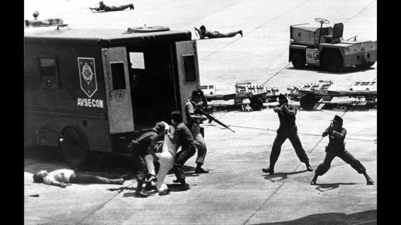 <strong>People's champion dies</strong>: Former Philippine senator Benigno Aquino is lifted up by security after he was fatally shot in the head at Manila International Airport on August 21, 1983. He was returning home after three years of self-exile. Aquino spoke out against the authoritarian rule of Philippine President Ferdinand Marcos and <a href="index.php?page=&url=http%3A%2F%2Fwww.britannica.com%2Fbiography%2FBenigno-Simeon-Aquino-Jr" target="_blank" target="_blank">intended to run</a> against him. His assassin, left, was shot by security.