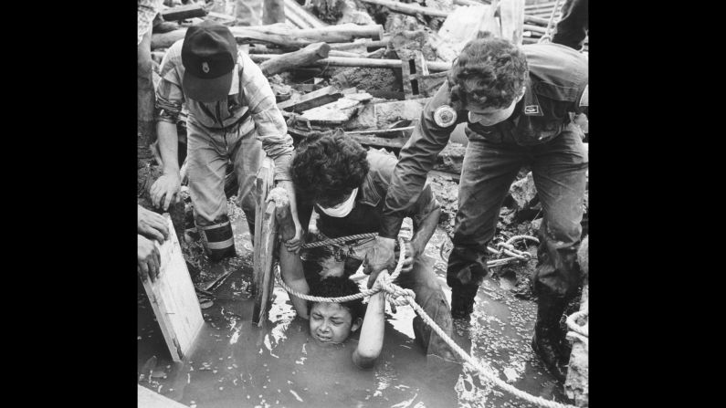 <strong>Eruption in the Andes:</strong> Rescuers attempt to save 13-year-old Omayra Sanchez, who became trapped by debris after the eruption of Nevado Del Ruiz, a volcano in northern Colombia, on November 13, 1985. The disaster occurred at night, when residents of the nearby town of Armero were sleeping, and <a href="index.php?page=&url=http%3A%2F%2Fnews.bbc.co.uk%2Fonthisday%2Fhi%2Fdates%2Fstories%2Fnovember%2F13%2Fnewsid_2539000%2F2539731.stm" target="_blank" target="_blank">about 20,000 people perished</a> as a result. Sanchez eventually died as well after 60 hours stuck in mud and rubble.