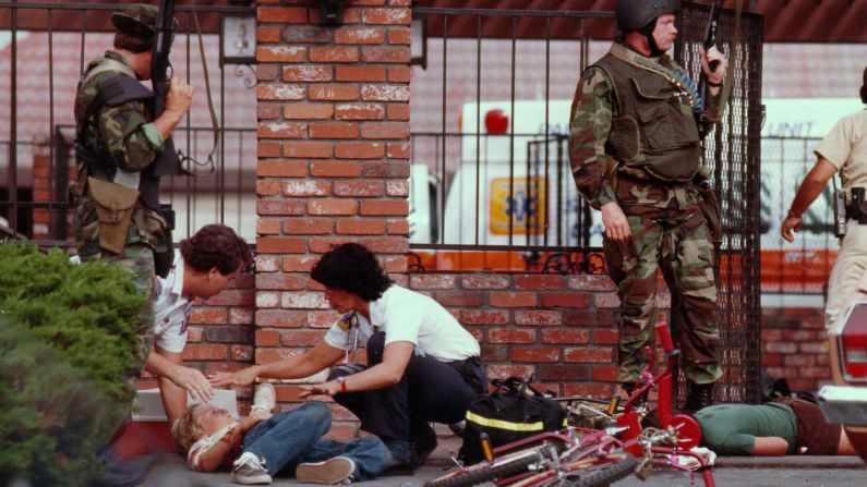 <strong>McDonald's massacre:</strong> On July 18, 1984, 41-year-old James Oliver Huberty walked into a McDonald's in San Ysidro, California, and opened fire, <a href="index.php?page=&url=http%3A%2F%2Fwww.kusi.com%2Fstory%2F26058350%2Fsurvivors-recount-san-ysidro-mcdonalds-massacre-after-30-years" target="_blank" target="_blank">killing 21 people</a> and injuring 19 others before he was shot by a police sniper. It was the biggest massacre <a href="index.php?page=&url=http%3A%2F%2Fwww.cnn.com%2F2013%2F09%2F16%2Fus%2F20-deadliest-mass-shootings-in-u-s-history-fast-facts%2F" target="_blank">the United States had seen</a> to date. Here, paramedics attend to a wounded boy outside the restaurant. 