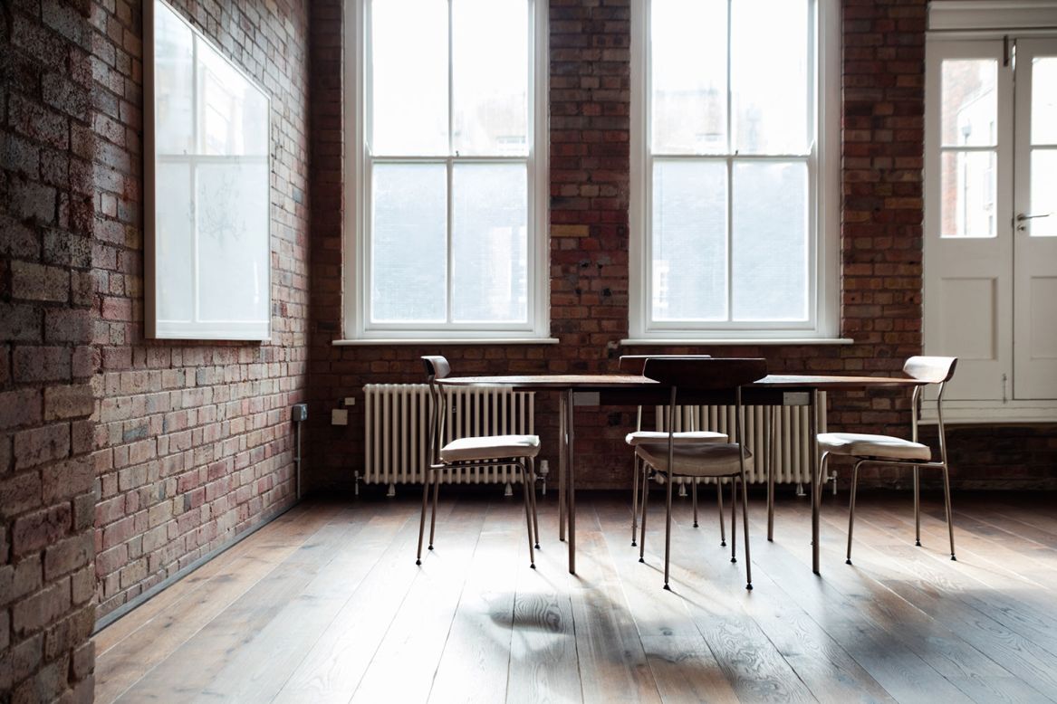 His London home has beds, a table and a few chairs. 