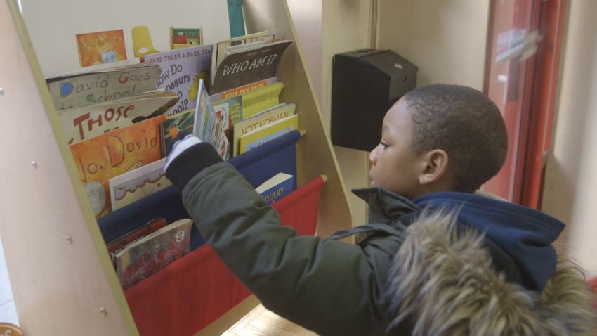 boy looking at barbershop books