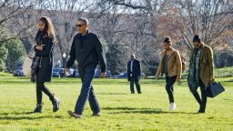 U.S. President Barack Obama and his family (L-R) Malia, Sasha, and first lady Michelle Obama return to the South Lawn of the White HouseJanuary 3, 2016 in Washington, DC.