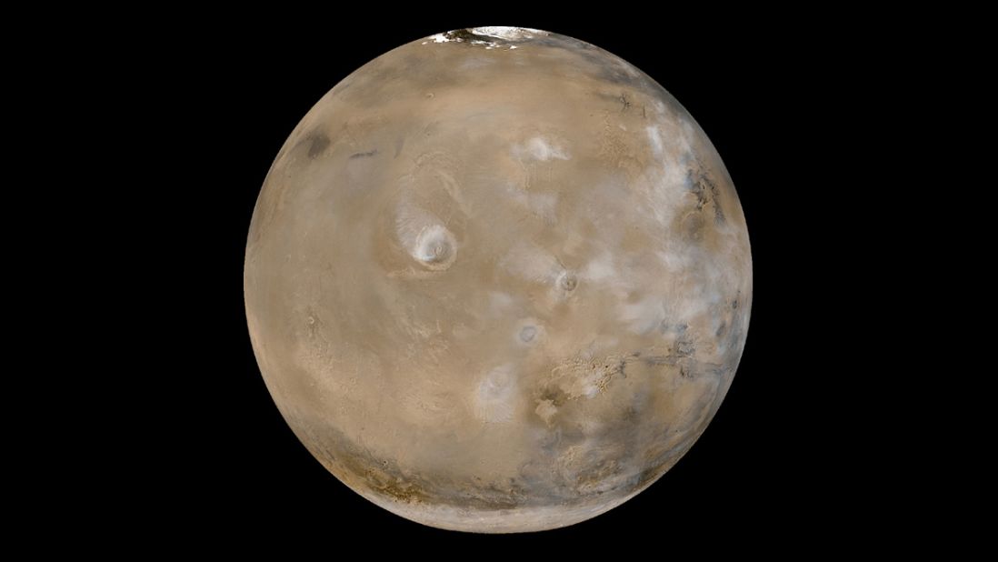 This view of Mars shows huge volcanoes in what's called the Tharsis Montes region. The photo is a composite of 24 images taken on February 14, 2003, by the Mars Global Surveyor, a NASA spacecraft orbiting the red planet. NASA says Tharsis Montes is the largest volcanic region on Mars. It's about 2,485 miles (4,000 kilometers) across and 6 miles (10 kilometers) high. It contains 12 large volcanoes, including Olympus Mons, the largest of the Tharsis volcanoes.