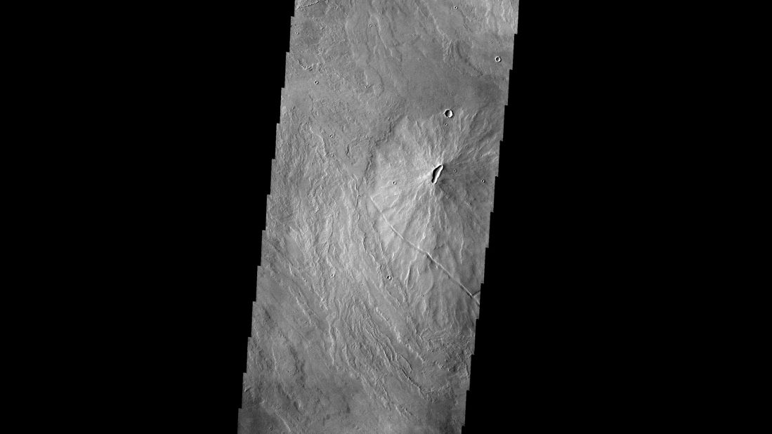 This image taken by the Mars Odyssey spacecraft shows volcanoes dotting the Martian landscape in the Tharsis region.