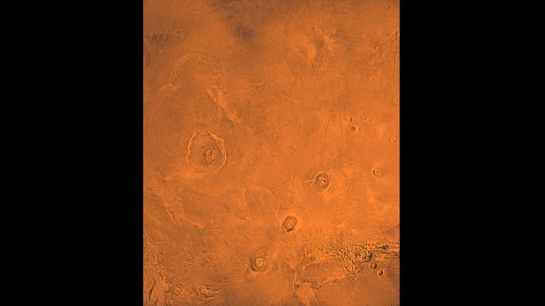 This image shows the Tharsis Bulge, a huge ridge on Mars covered by three large volcanoes (from lower left to right): Arsia, Pavonis and Ascraeus Mons. To the left is the huge Olympus Mons volcano.