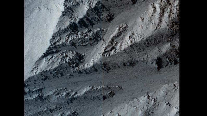 This image shows the northern edge of Olympus Mons on Mars. The cliff has hard layers of lava and soft layers that may be dust or volcanic ash. The image was taken by NASA's Mars Reconnaissance Orbiter on March 2, 2010.