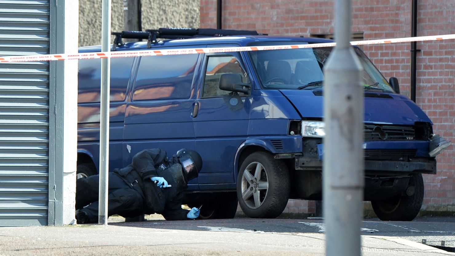 A bomb disposal unit officer checks a van damaged in a car bomb attack Friday in Belfast.