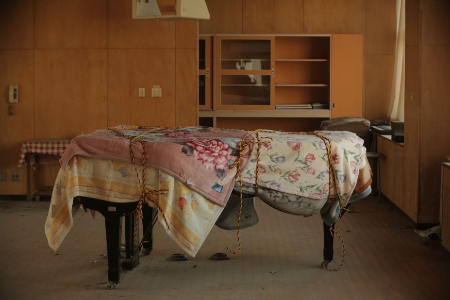 A dusty piano sits in an abandoned school near the Fukushima Daiichi nuclear plant. 