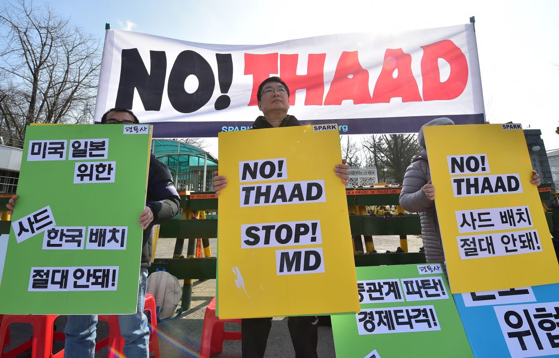 Anti-war activists hold placards during a rally against THAAD in 2016.