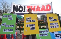 Anti-war activists hold placards during a rally against THAAD in 2016.