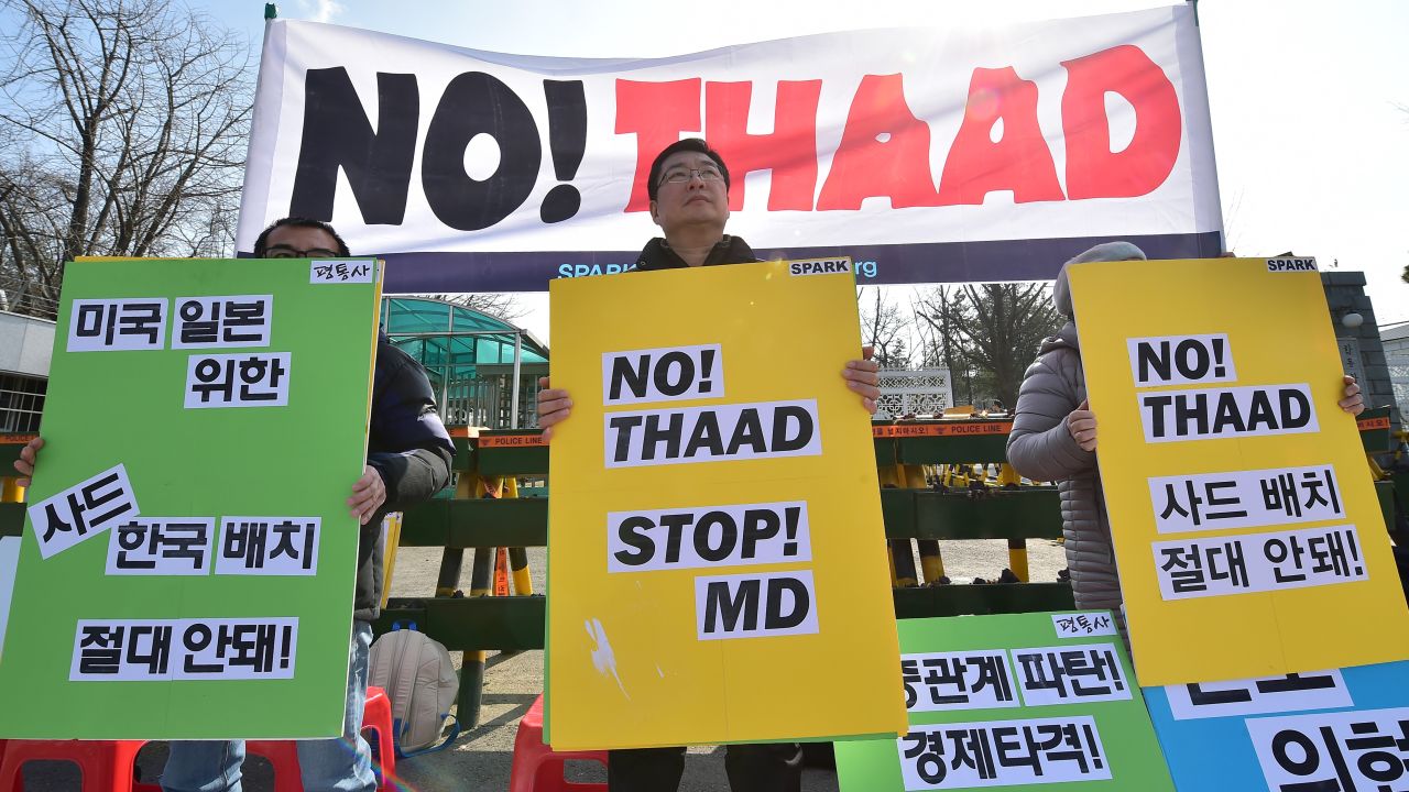 Anti-war activists hold placards during a rally against THAAD in 2016.