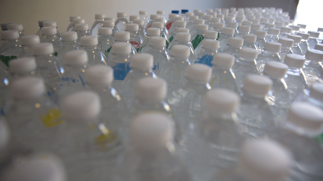 The total number of bottles of water the Luster family uses in one day.