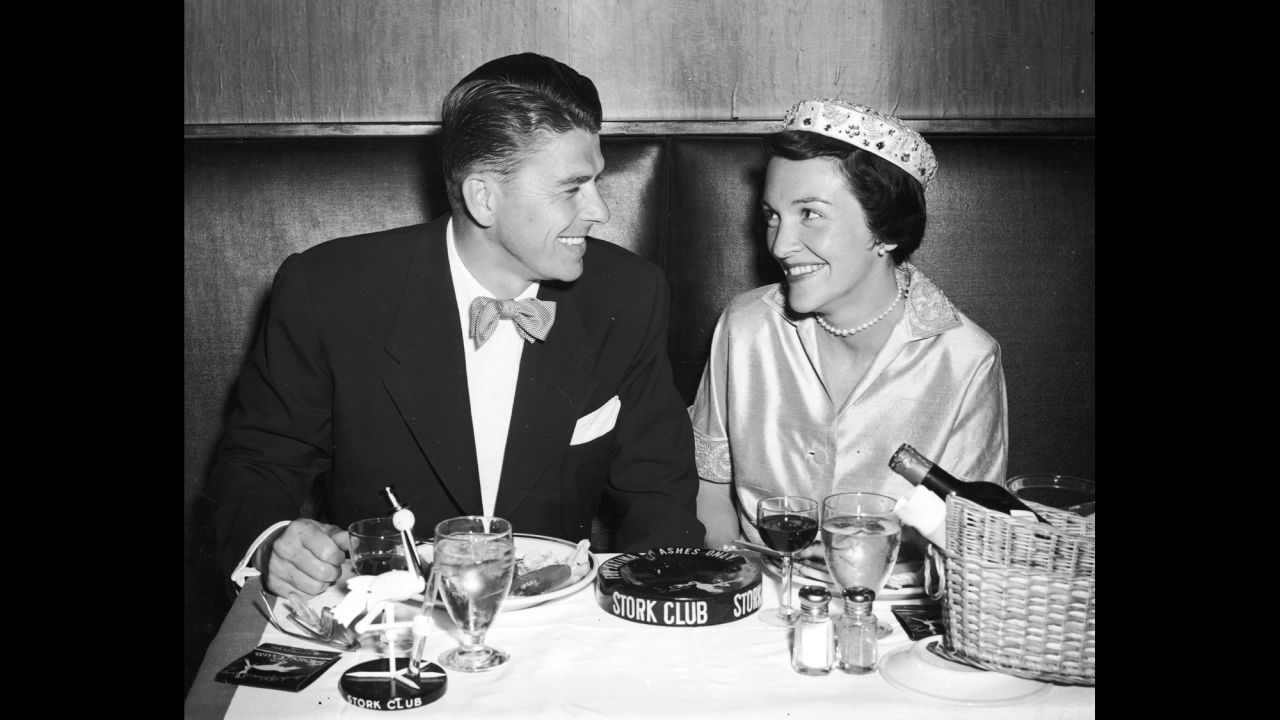 Ronald and Nancy Reagan smile as they have their honeymoon dinner at the Stork Club in New York City in 1952. 