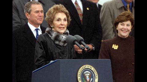 Nancy Reagan speaks as President George W. Bush and first lady Laura Bush look on at the christening ceremony of the aircraft carrier USS Ronald Reagan on March 4, 2001, in Newport News, Virginia. 