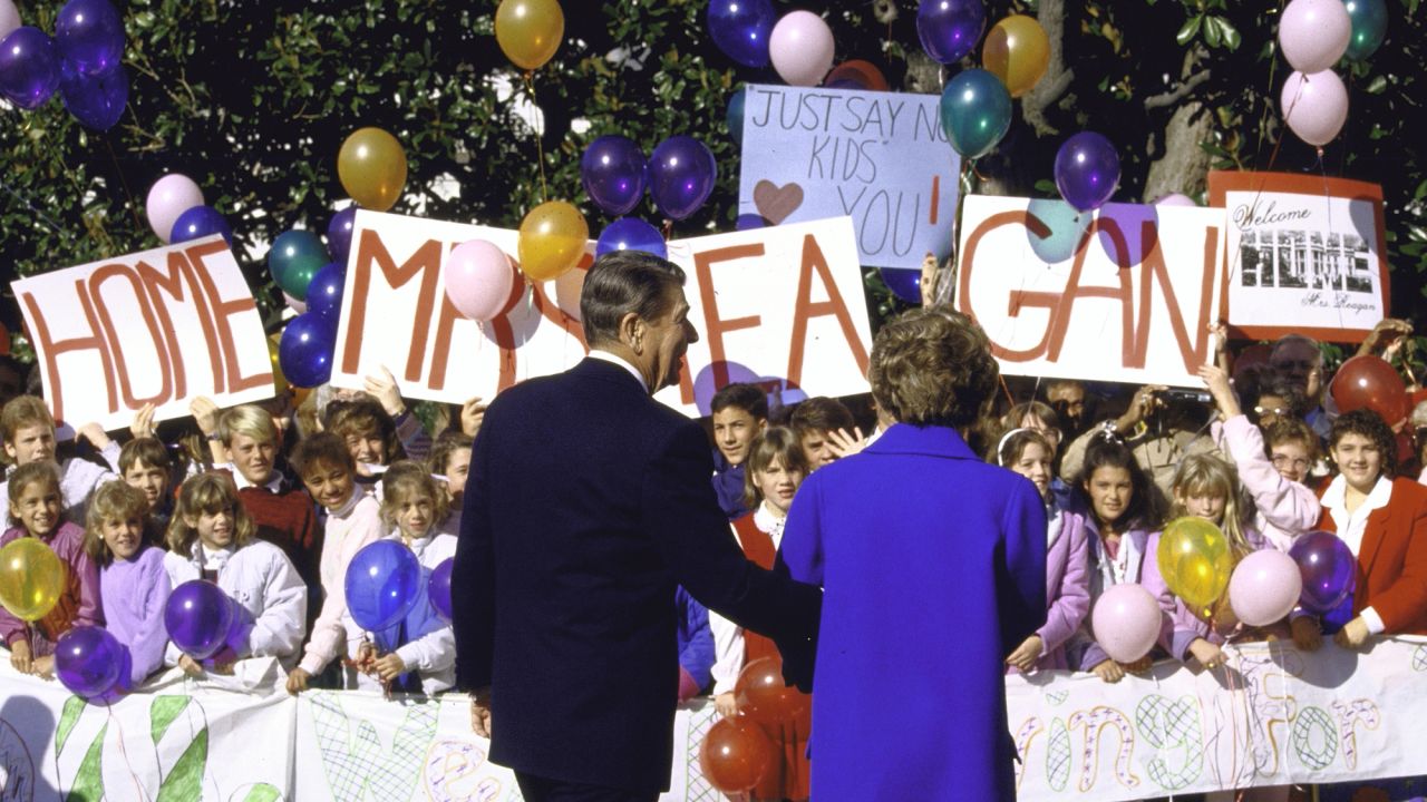 The Reagans are welcomed by youngsters with signs and balloons as Nancy returns to the White House after undergoing a mastectomy in October 1987.