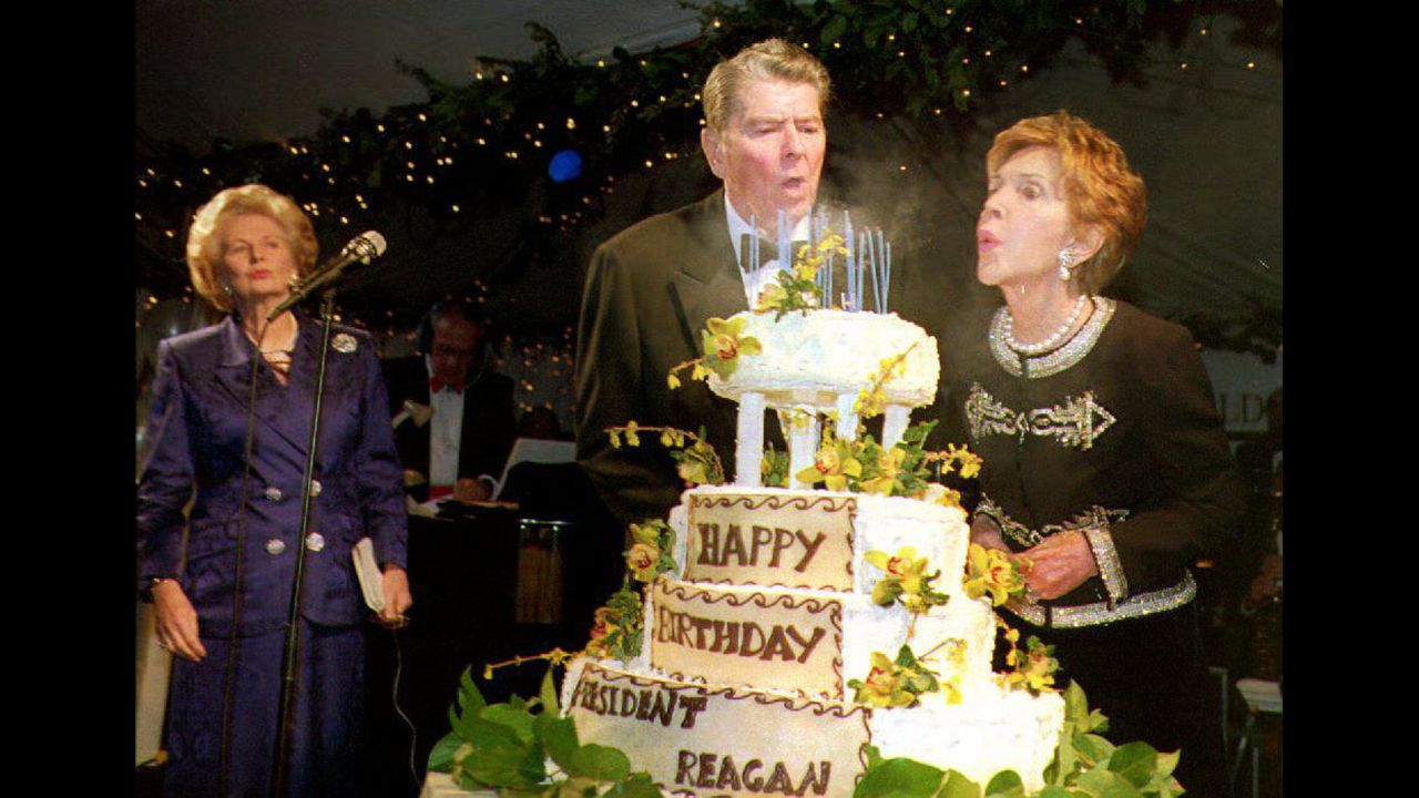 Ronald Reagan blows out the candles on his cake with help from Nancy as he celebrates his 82nd birthday on February 6, 1993. At left is former British Prime Minister Margaret Thatcher. 