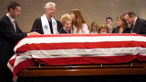Ron Reagan, Michael Wenning, Nancy Reagan, Patti Davis, Ashley Reagan and Michael Reagan pay their respects over the casket that contains the body of former President Ronald Reagan following the memorial service  on June 7, 2004, at the Ronald Reagan Presidential Library in Simi Valley, California.