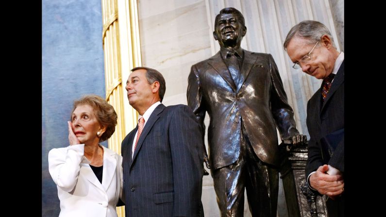 Reagan wipes away a tear after the unveiling of a statue of former President Ronald Reagan in the Rotunda of the U.S. Capitol on June 3, 2009. Also pictured, from left, are House Minority Leader John Boehner and Senate Majority Leader Harry Reid.