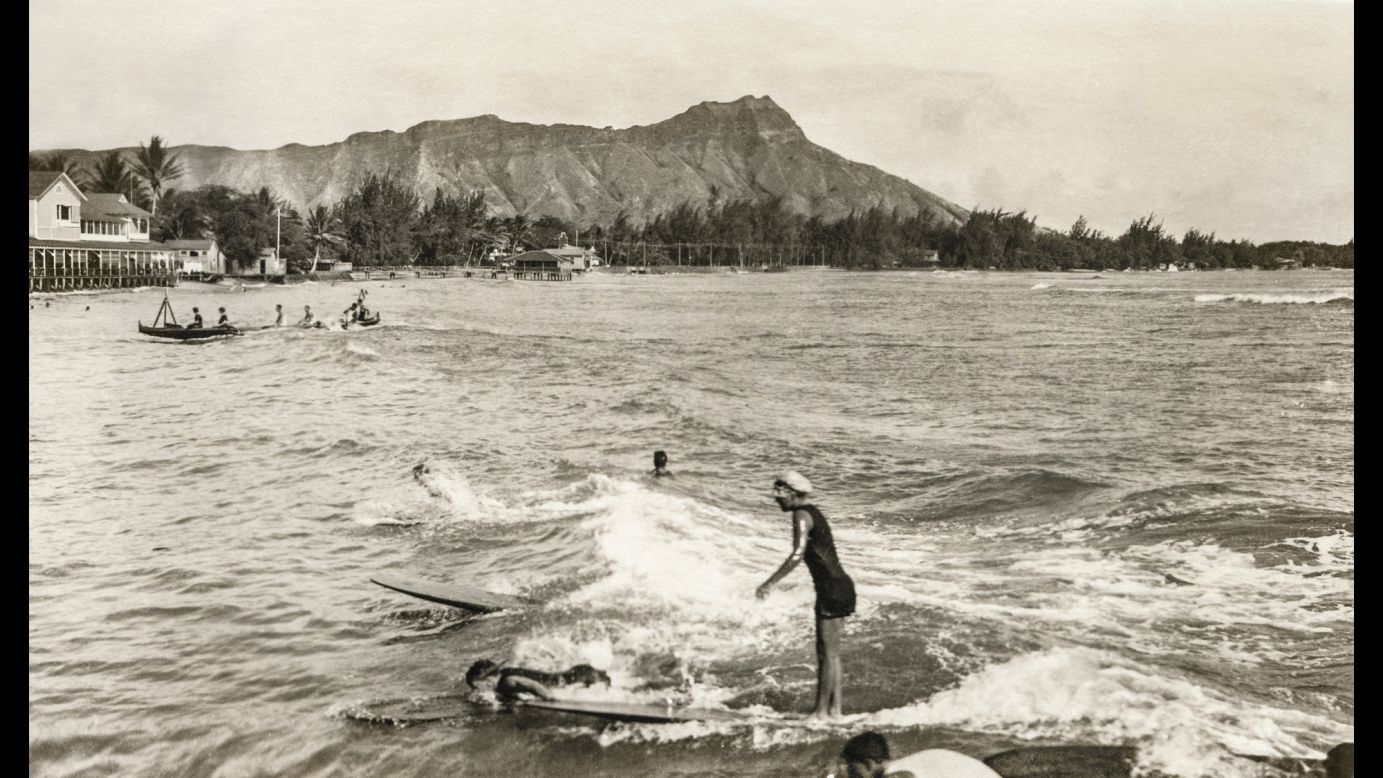 A surfer rides a wave at Waikiki Beach around 1914. Some of the sport's earliest forms trace back to ancient Polynesia in 2000 B.C.