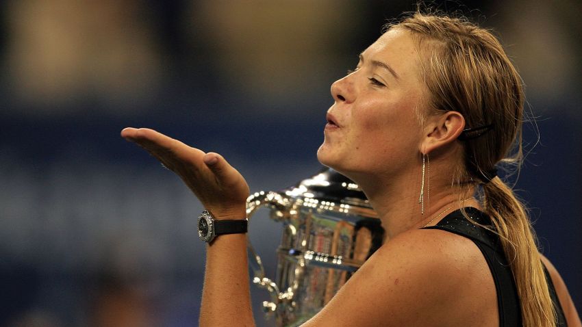Maria Sharapova of Russia blows kisses after receiving the championship trophy following her straight set victory over Justine Henin-Hardene of Belgium in the final of the U.S. Open at the USTA Billie Jean King National Tennis Center in Flushing Meadows Corona Park on September 9, 2006.