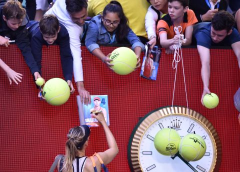 Sharapova signs autographs after winning a match at last  year's Australian Open. She later announced she had tested positive for banned drug meldonium and was banned for two years, later reduced to 15 months. 