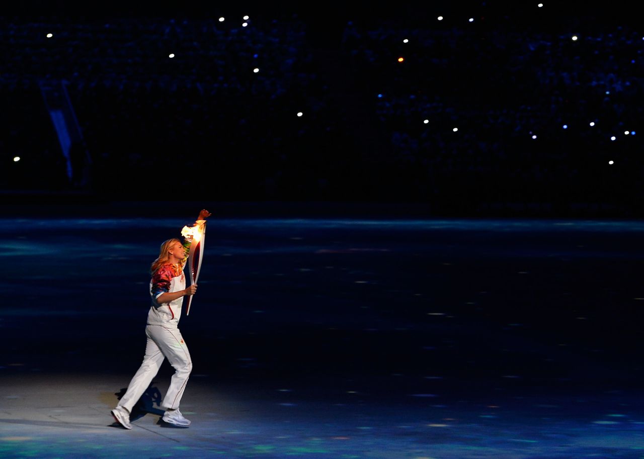 Sharapova carries the Olympic torch in Sochi, Russia, during the opening ceremony for the 2014 Winter Olympics.