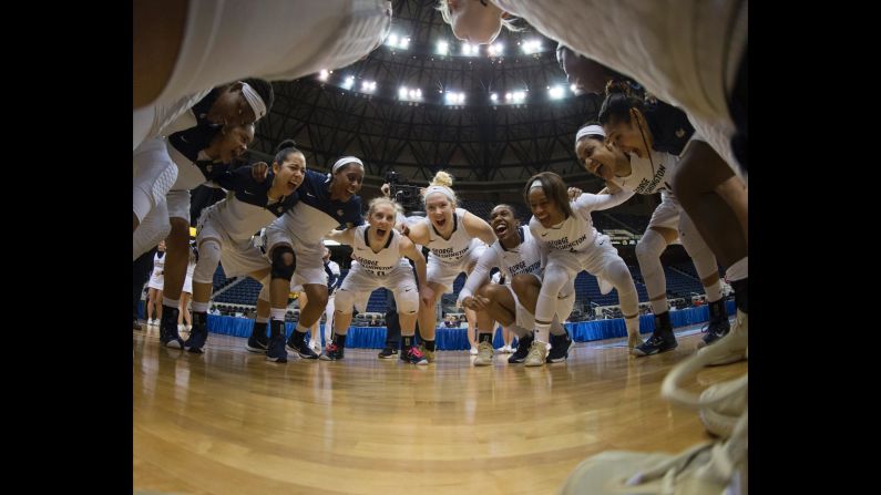 Basketball players from George Washington University huddle before an Atlantic 10 tournament game on Friday, March 4. The team won the tournament for the second straight season.