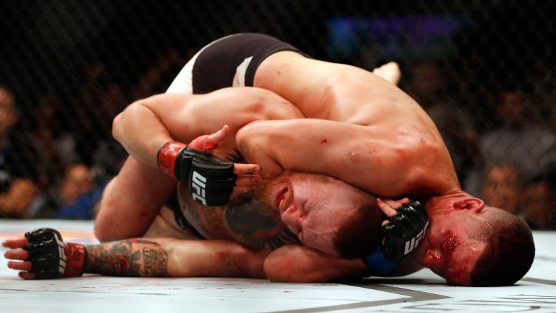 Nate Diaz chokes Conor McGregor on his way to winning the main event of UFC 196 on Saturday, March 5. The second-round submission was McGregor's first loss since November 2010.