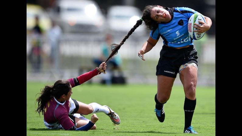 Venezuela's Maryoly Gomez pulls the hair of Uruguay's Victoria Rios during a rugby sevens match in Rio de Janeiro on Sunday, March 6.