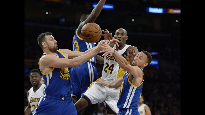 Kobe Bryant is swarmed by Golden State defenders during an NBA game in Los Angeles on Sunday, March 6. Bryant and the Lakers had a record of 12-51 coming into the game, but they upset the league-leading Warriors 112-95. It was only the sixth loss of the season for Golden State (55-6).