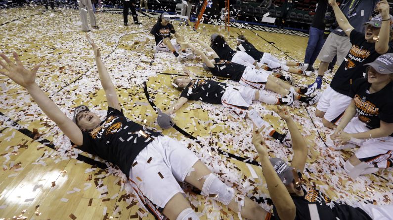 Oregon State basketball players roll in confetti after winning the Pac-12 tournament on Sunday, March 6. They beat UCLA in the final 69-57.