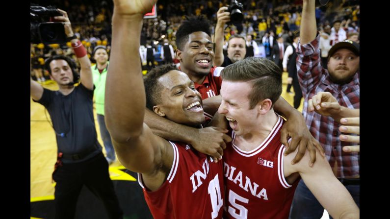 Indiana guard Yogi Ferrell, left, celebrates with teammate Harrison Niego, right, after the Hoosiers defeated Iowa and clinched the Big Ten regular-season title on Tuesday, March 1. Ferrell, the team's starting point guard, finished with 20 points.