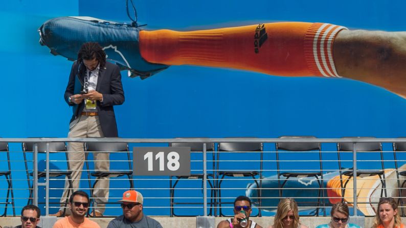 A soccer fan looks at his cell phone during an MLS game in Houston on Sunday, March 6.