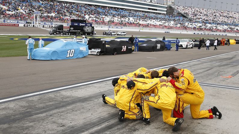 A NASCAR pit crew kneels in prayer before the Sprint Cup race in Las Vegas on Sunday, March 6.