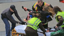 BOSTON - APRIL 15: (EDITOR'S NOTE: THIS IMAGE CONTAINS GRAPHIC CONTENT) Victoria McGrath, who was injured in an explosion near the finish line of the 117th Boston Marathon, is taken away from the scene on a stretcher. (Photo by David L. Ryan/The Boston Globe via Getty Images)