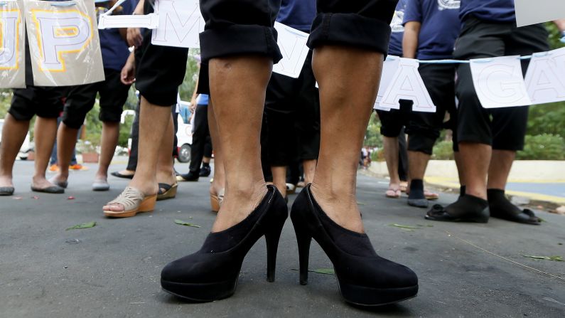 Male students wearing high-heeled shoes prepare to march around a park in Quezon City, Philippines, to pay tribute to women all over the world on March 7.
