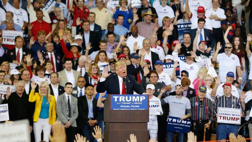 Republican presidential candidate Donald Trump speaks to the crowd asking them to take a pledge to promise to vote for him during a campaign rally, Saturday, March 5, 2016, in Orlando, Fla. (AP Photo/Brynn Anderson)