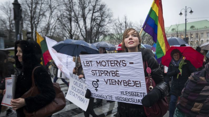 Women in Vilnius, Lithuania, march for gender equality and women's rights on International Women's Day, Tuesday, March 8. The poster reads: "Women's strength in unity." International Women's Day calls for the end of all forms of discrimination and violence against women and girls.