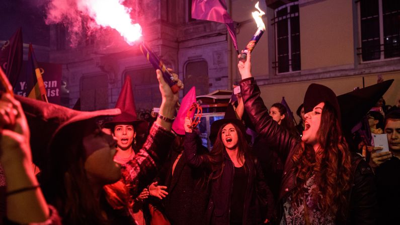 Women light flares and wave flags during a march in Istanbul on March 8.