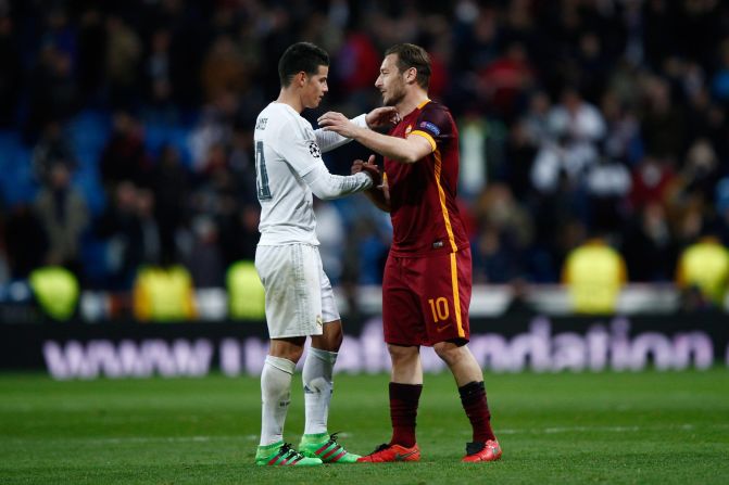 Goalscorer James Rodriguez of Real Madrid shakes hands with Francesco Totti of Roma -- who is playing in his 24th season -- following  the UEFA Champions League Round of 16 Second Leg match between Real Madrid and Roma at Estadio Santiago Bernabeu on March 8, 2016. 