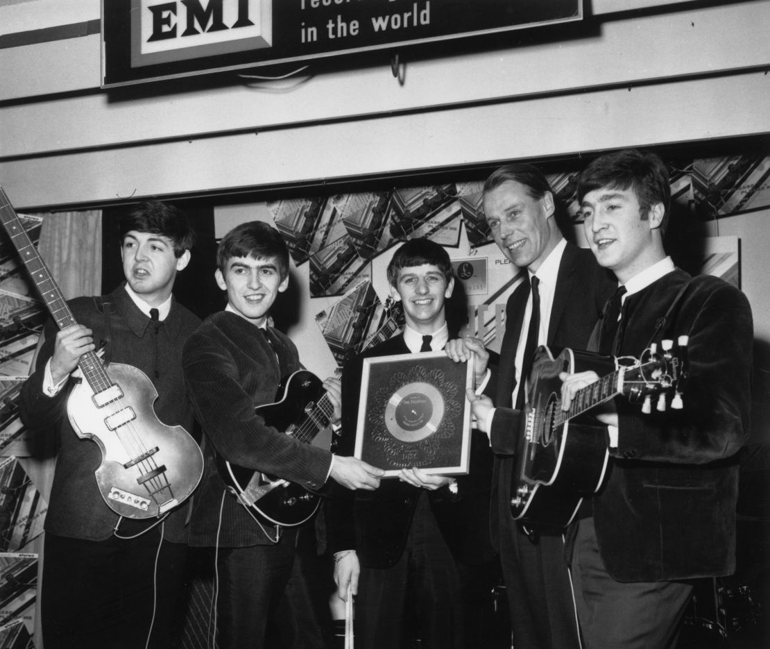 George Martin pictured with the Beatles in 1963. 