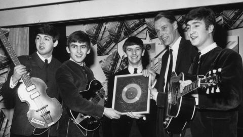 George Martin pictured with the Beatles in 1963. 