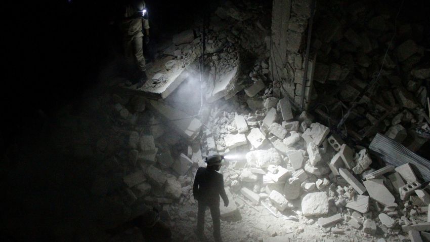 ALEPPO, SYRIA - JULY 09: Search and rescue team members inspect collapsed buildings after Asad Regime forces' attack on residential areas in Karm al-Beik region of Aleppo, Syria on July 09, 2015. (Photo by Beha El Halebi/Anadolu Agency/Getty Images)