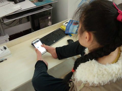 Sun Lukang types on her smartphone with two toes. 